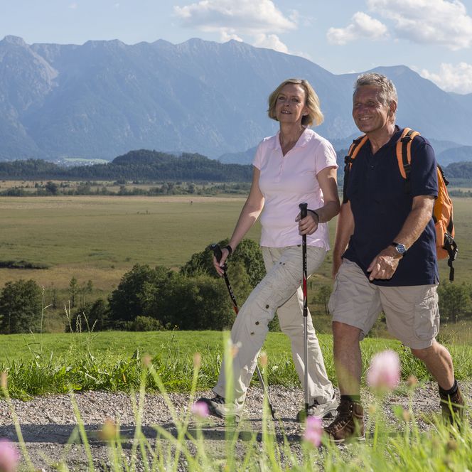 Ein Paar wandert auf einem Wanderweg am Murnauer Moos.